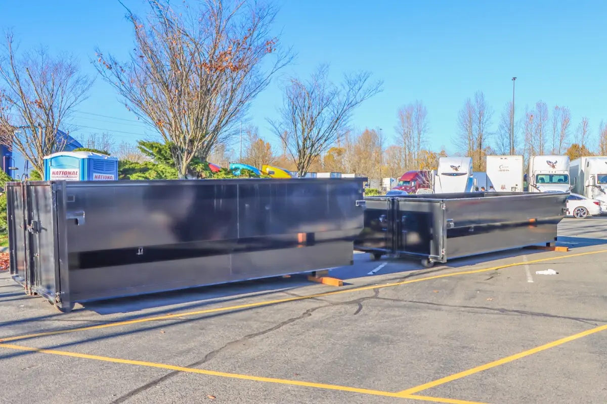 Professional dumpster rental service with roll-off container on residential driveway in Point Pleasant Beach